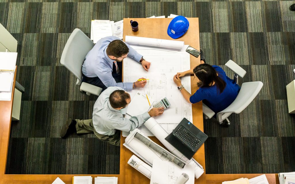 people sitting behind table and talking about investing risk ratio